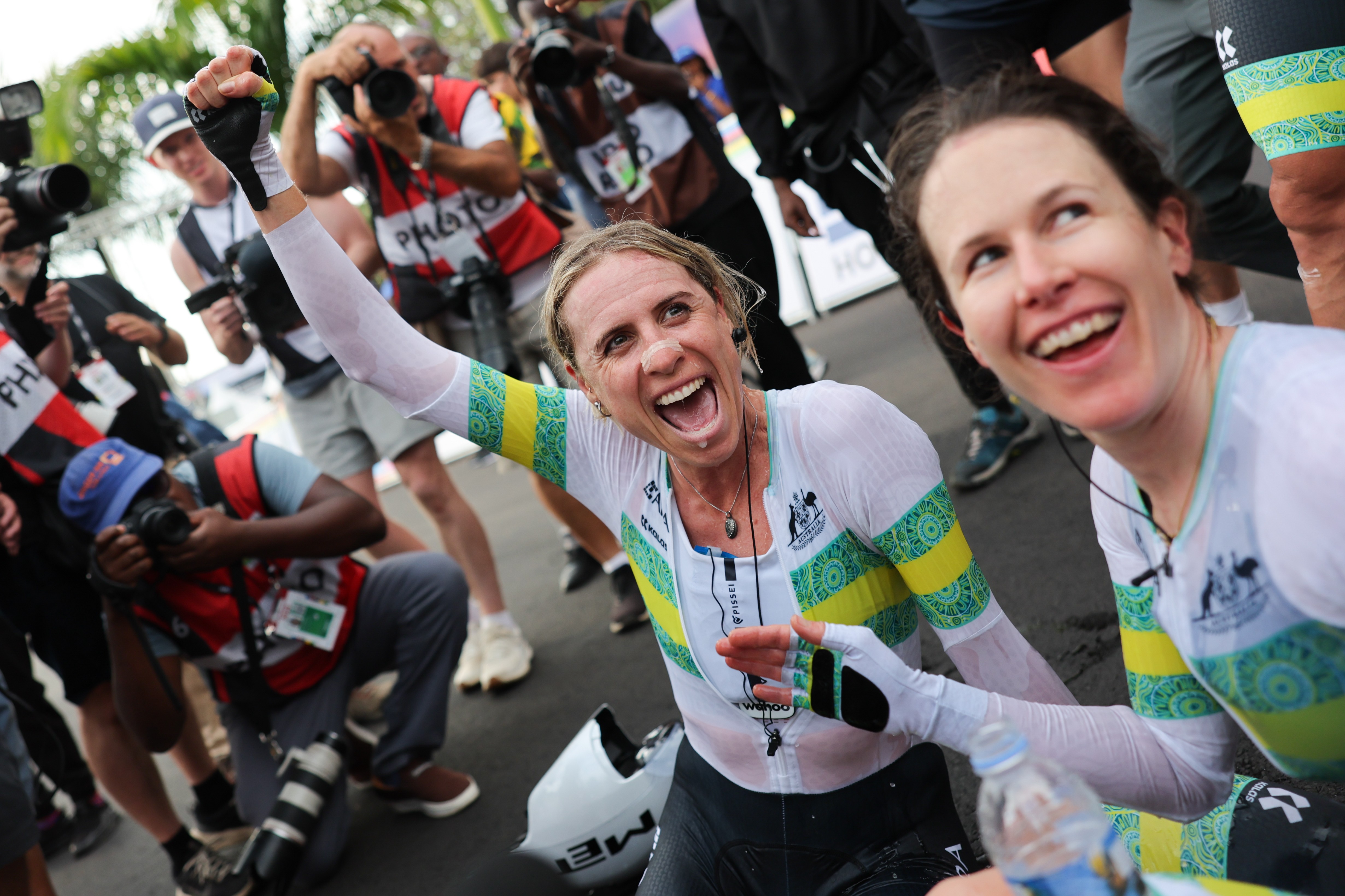 Brodie Chapman celebrates with Amanda Spratt after winning the 2025 UCI Road World Championships mixed relay team time trial with the ARA Australian Cycling Team in Kigali, Rwanda